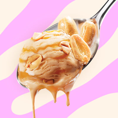 Pint of N!CK'S Peanut Caramel Crunch light ice cream. The label highlights 'no added sugar' and '360 calories/pint'. A spoon holds a scoop of caramel ice cream with peanuts and a caramel swirl.