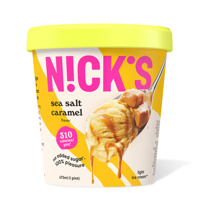 Pint of N!CK'S Sea Salt Caramel light ice cream. The label highlights 'no added sugar' and '310 calories/pint'. A spoon holds a scoop of caramel ice cream with a sea salt caramel swirl and pieces.